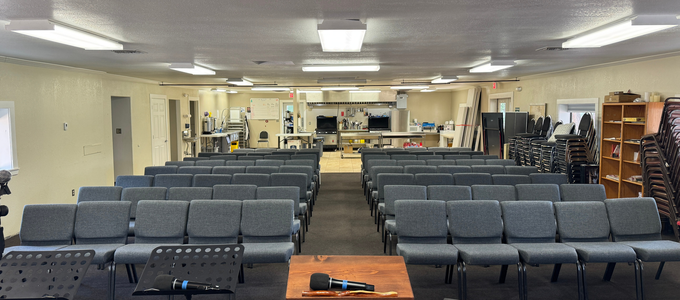 Meeting hall with rows of seating facing a podium