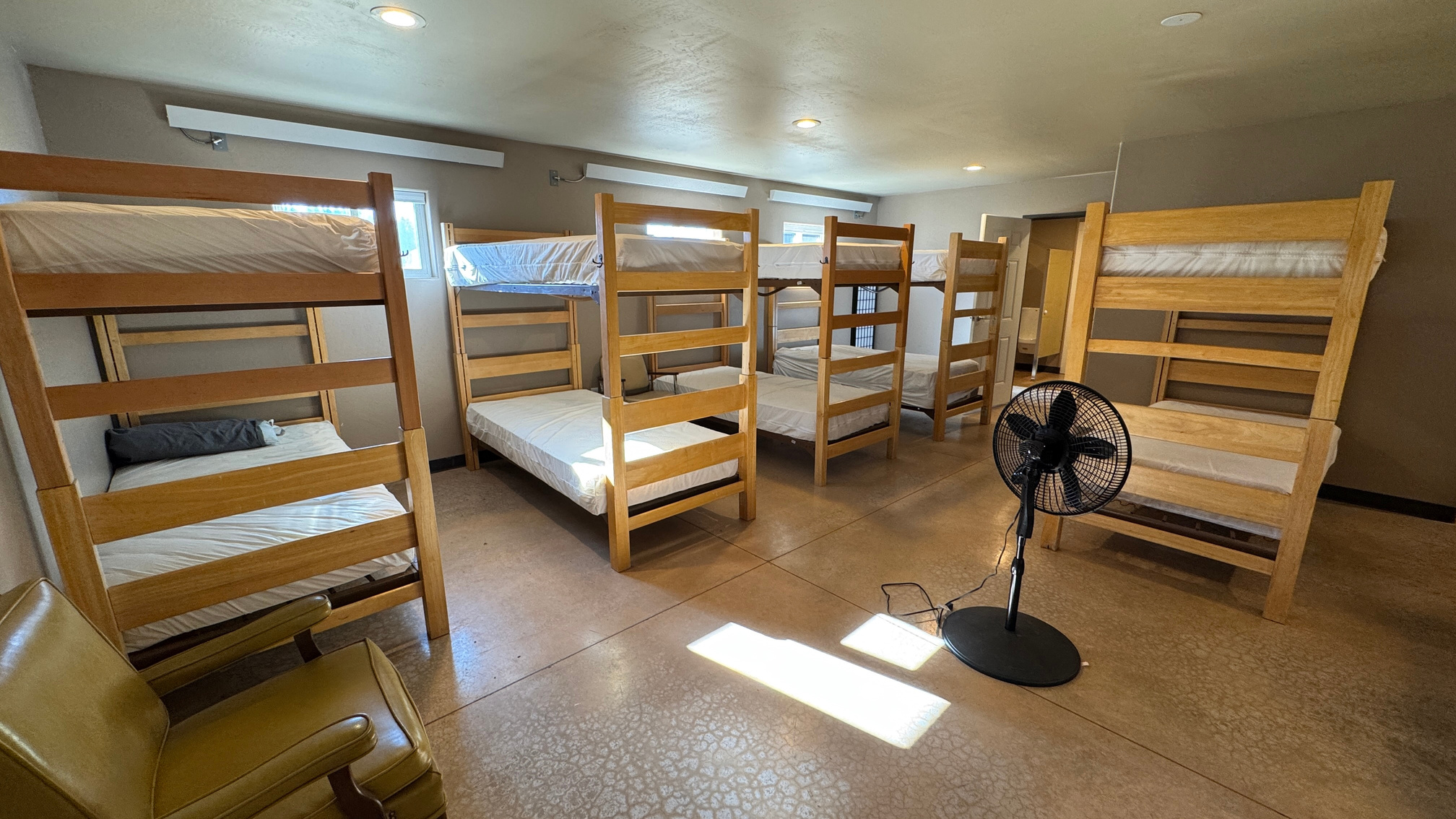 Bunkhouse-style dormitory with wooden bunk beds